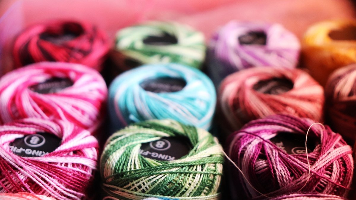 Colorful embroidery threads arranged in rows.